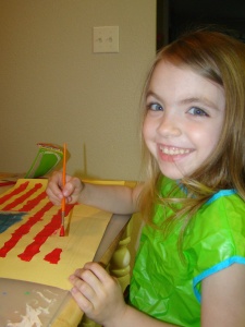 Anna painting a picture of an American Flag.