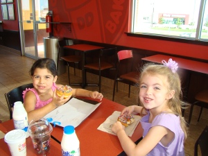 Anna and Zoe eating donuts for Anna's breakfast celebration for the first day of school.